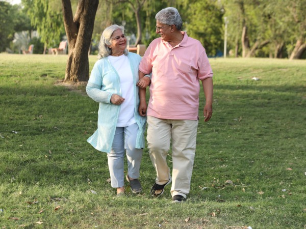 Indian happy senior couple enjoying in garden and looking together